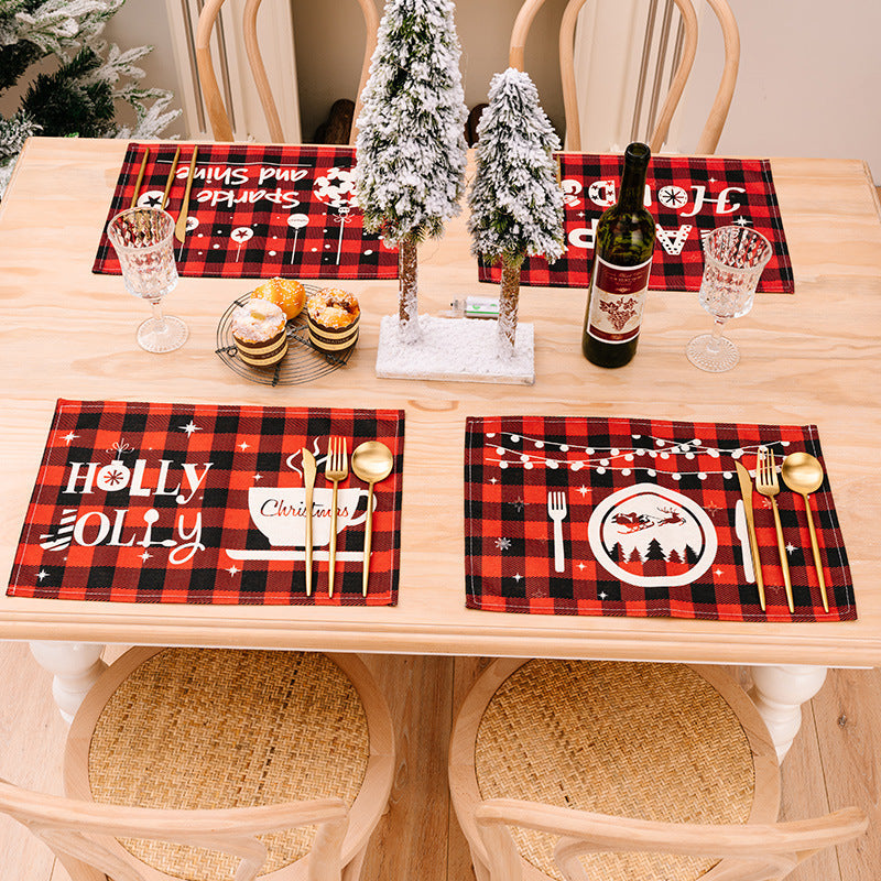 Festive plaid placemats and runner with Christmas designs in red and black.