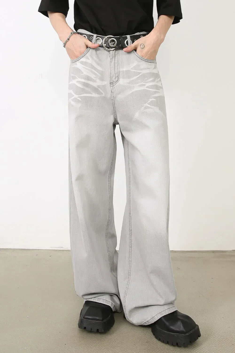 Bleached wash wide-leg denim trousers in gray with a unique abstract pattern.