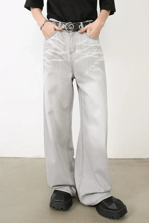 Bleached wash wide-leg denim trousers in gray with a unique abstract pattern.