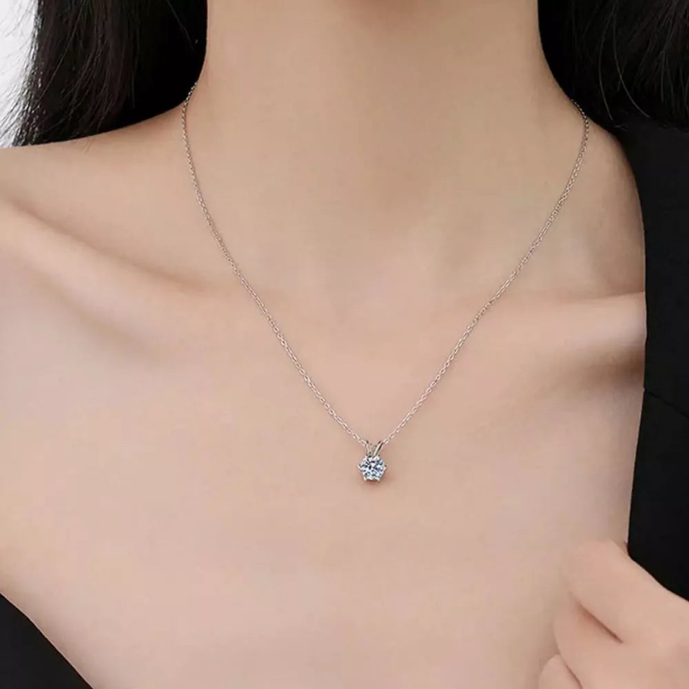 Elegant moissanite pendant necklace in sterling silver with a delicate chain.