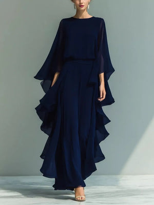 Navy chiffon cape dress with ruffled tiered skirt and round neckline.