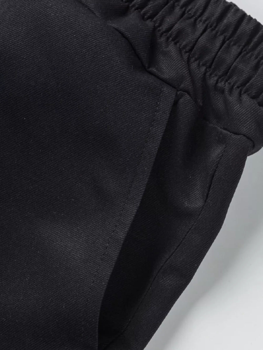 Black cargo shorts with elastic waistband and pocket detail