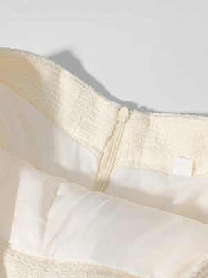 Textured cream tweed skirt detail with zipper and satin lining