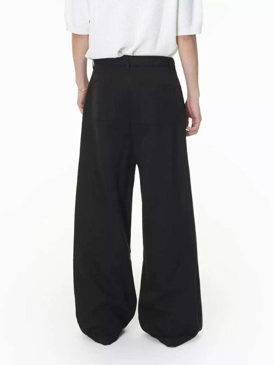 Black wide-leg pleated sweatpants with a belted waist and two back pockets.