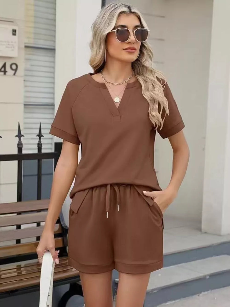 Brown relaxed two-piece set with v-neck top and drawstring shorts with pockets.