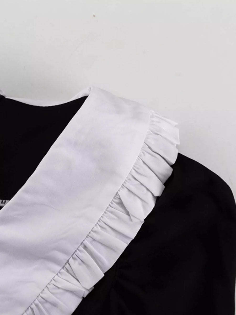 Black dress with white ruffled collar and trim