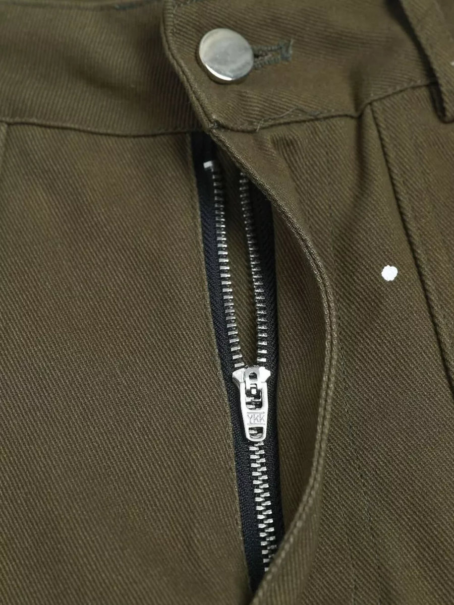 Olive green cotton cargo pants with white paint splatter detail and YKK zipper.