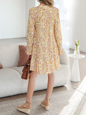 Floral print loose shirt dress with button-down front and ruffled cuffs.