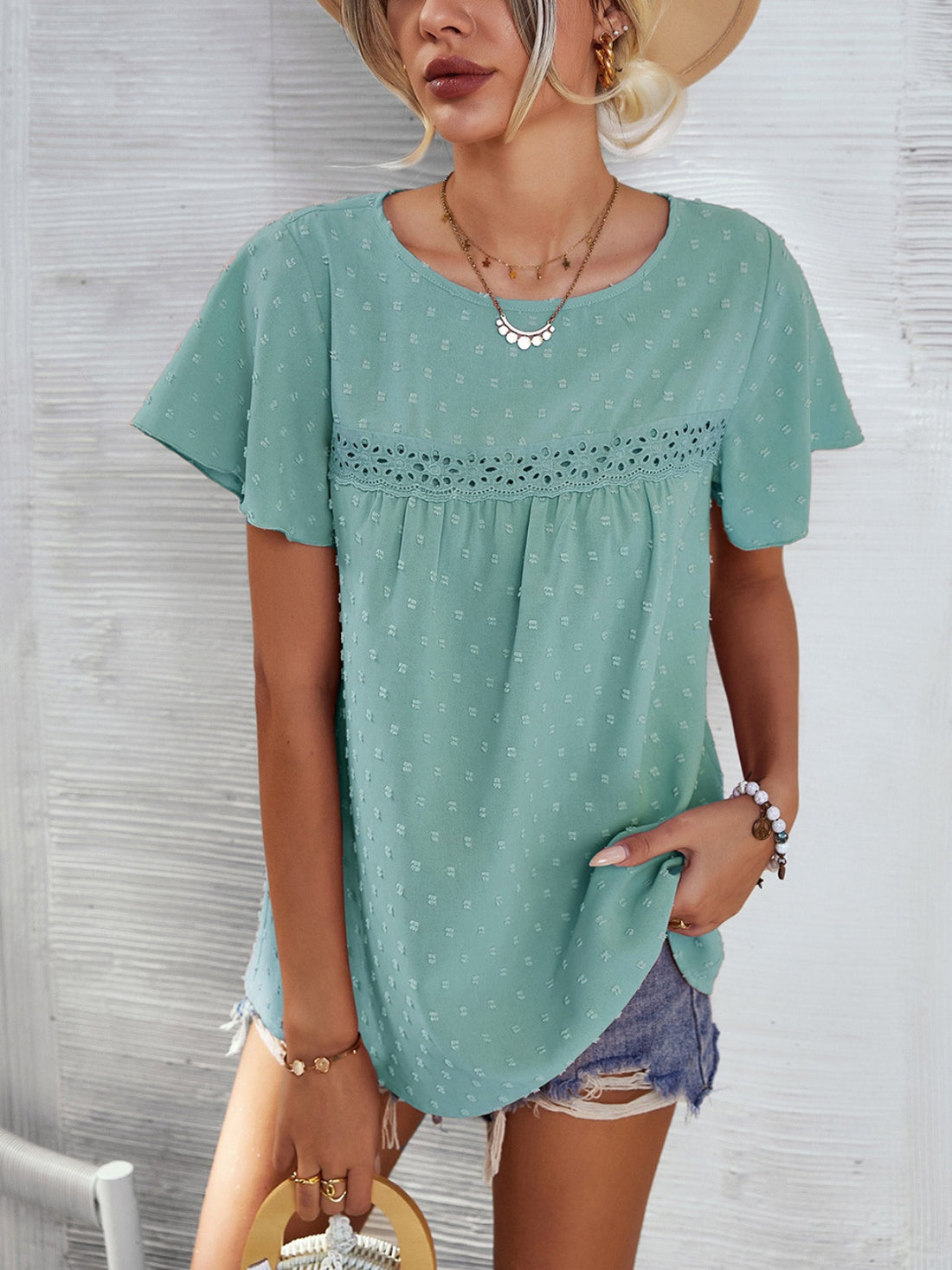 Light green Swiss dot blouse with flutter sleeves and eyelet detail.
