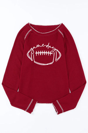 Burgundy waffle knit crewneck top with white "game day" football graphic and contrast stitching.