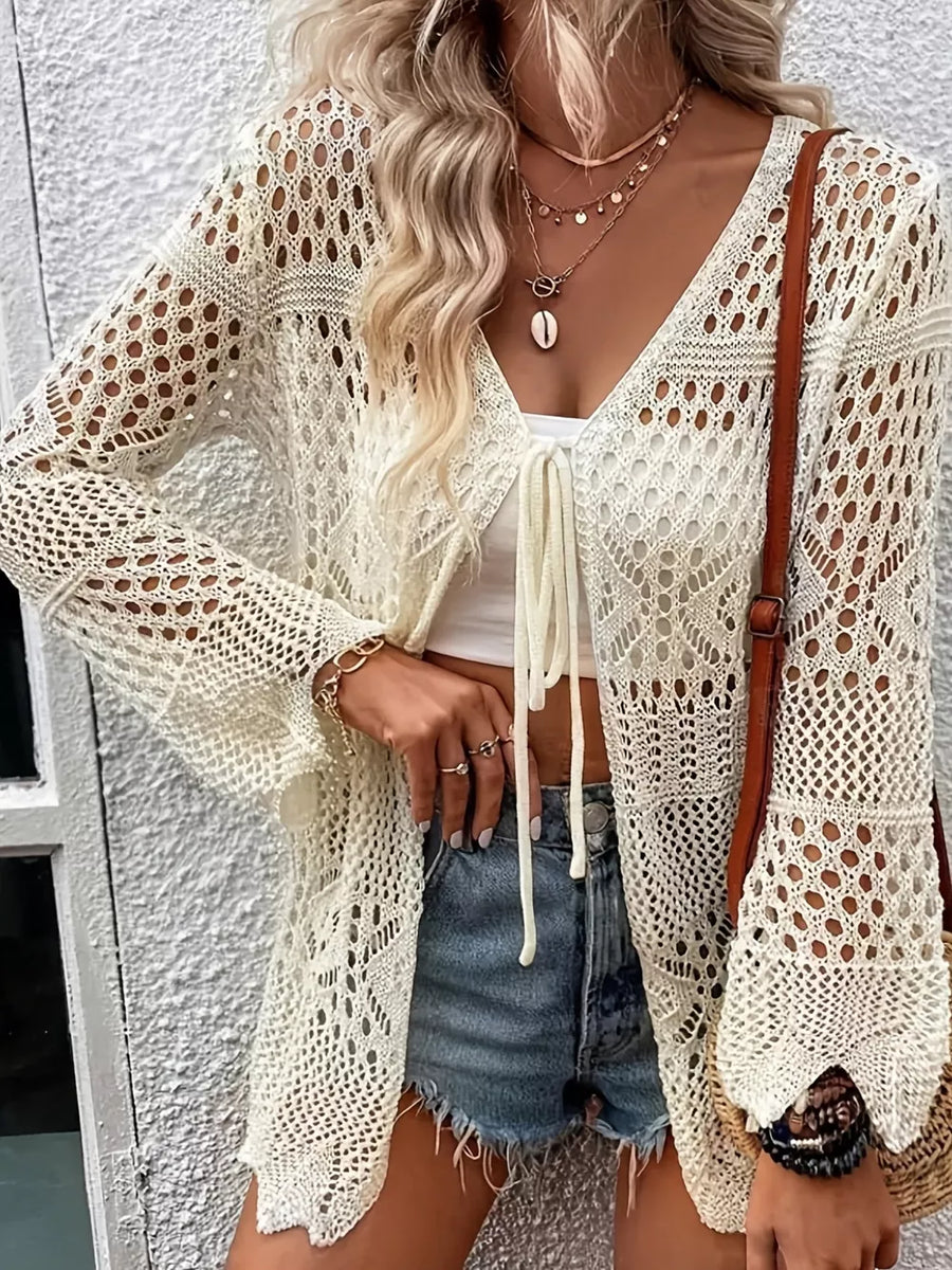 Cream crochet open front cardigan with tie closure and bell sleeves.