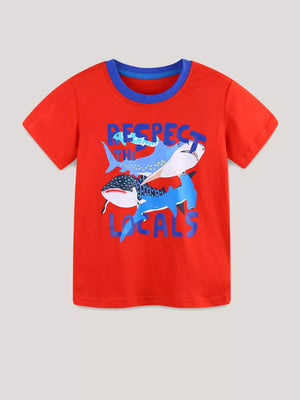 Children's red t-shirt with blue trim and cartoon sharks graphic that says Respect The Locals.