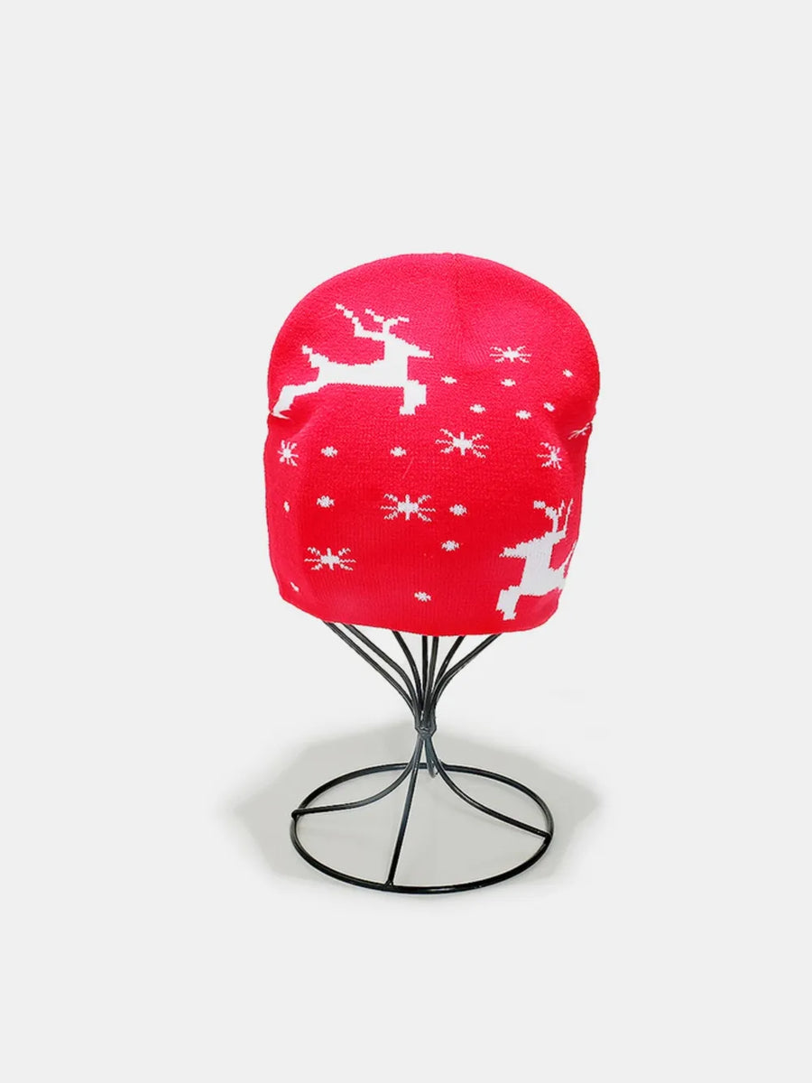 Red acrylic beanie with white reindeer and snowflake pattern.