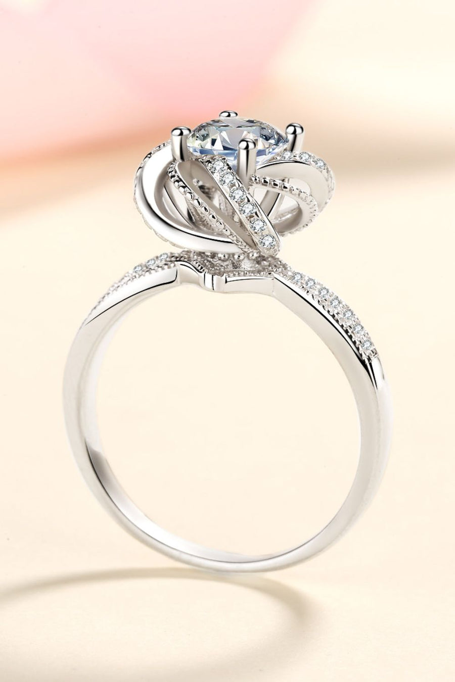 Silver halo ring with moissanite and pavé details.