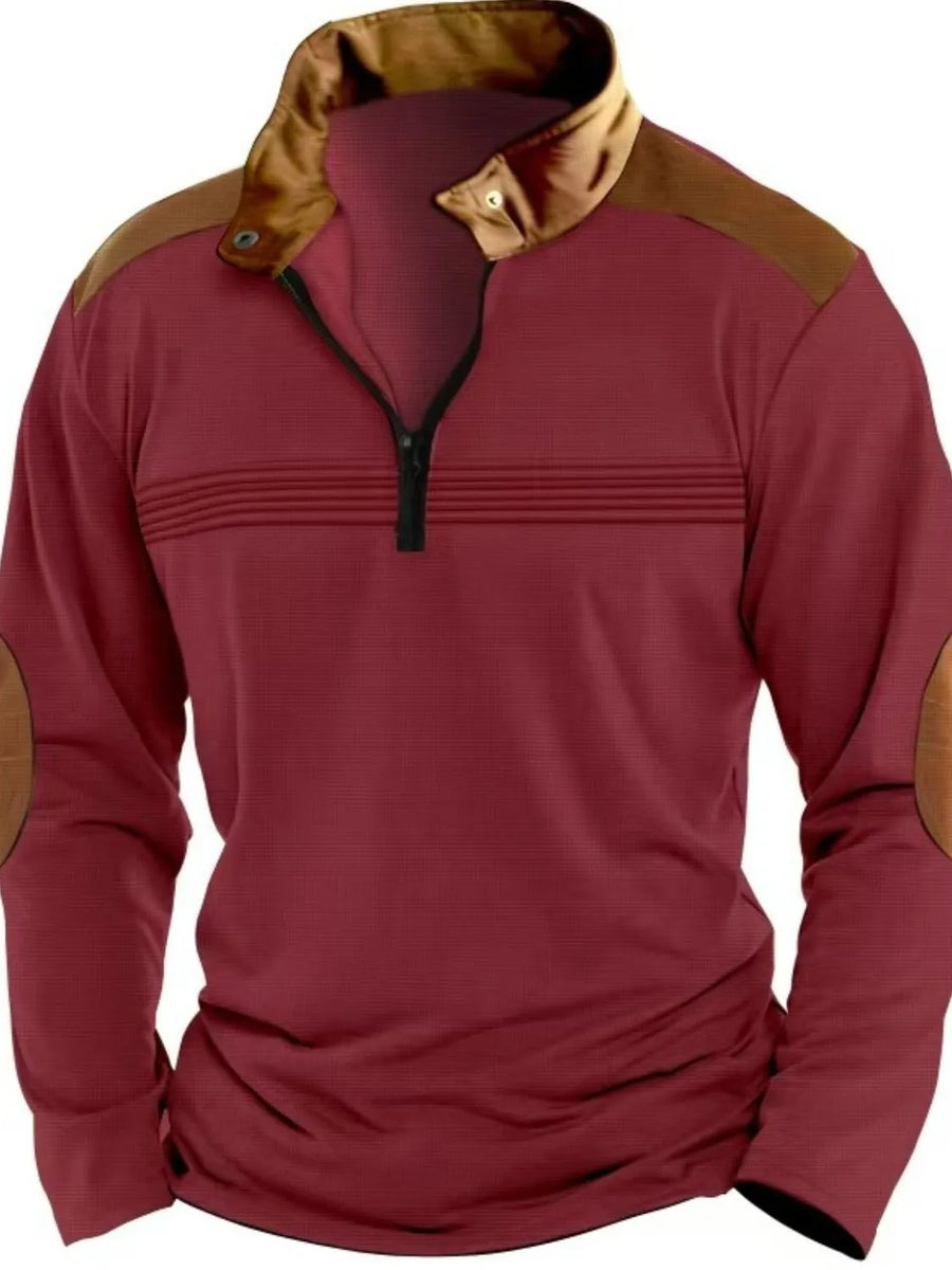 Burgundy quarter-zip pullover with contrast collar, shoulder panels, elbow patches, and horizontal chest stripes.
