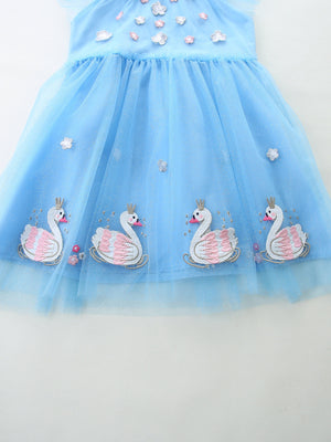 Blue tulle baby dress with swan embroidery and cap sleeves.