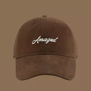 Brown cotton baseball cap with white embroidered "Amazed" text.