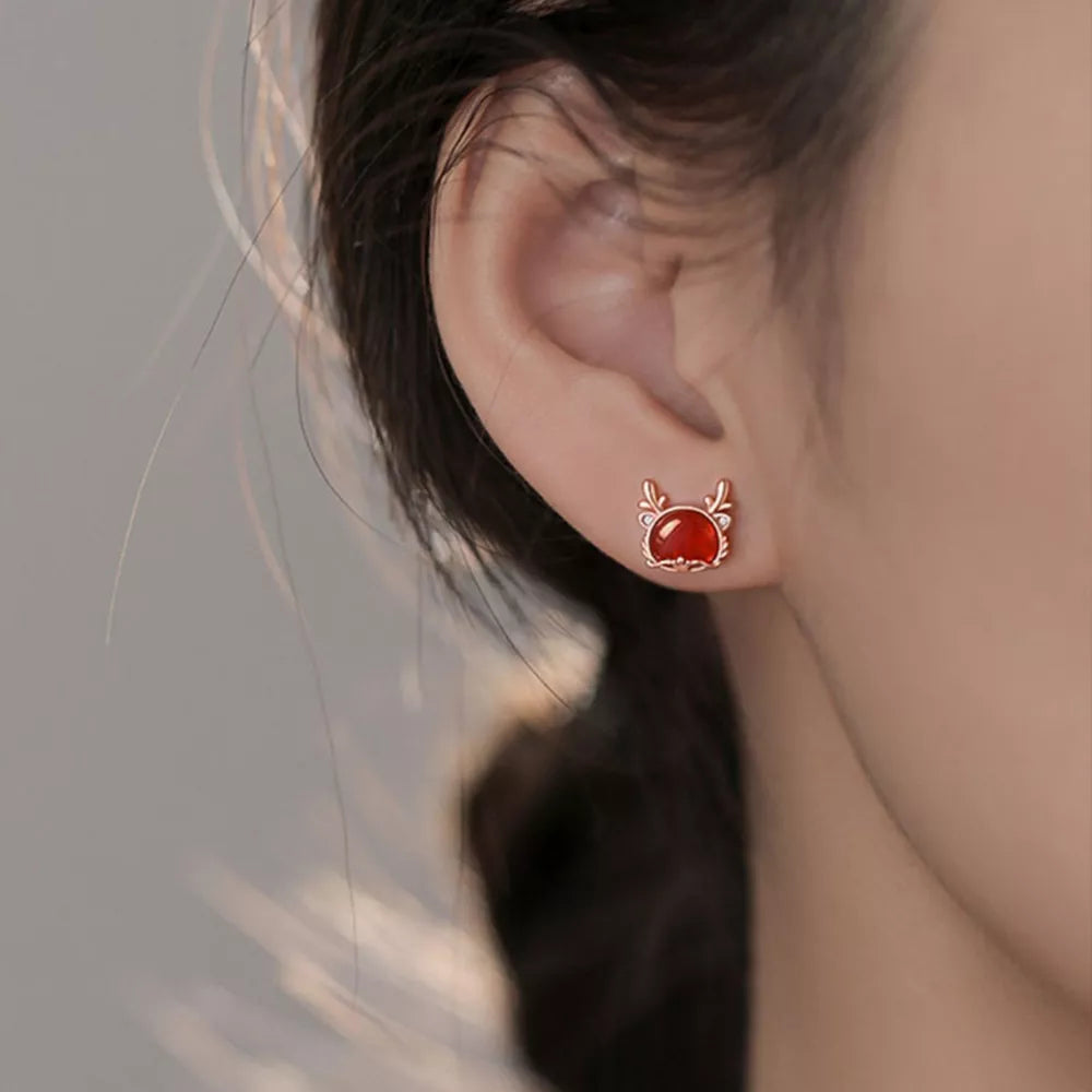 earrings in rose gold featuring deer motif and N/A fit