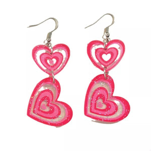 Pink layered heart dangle earrings with glitter accents
