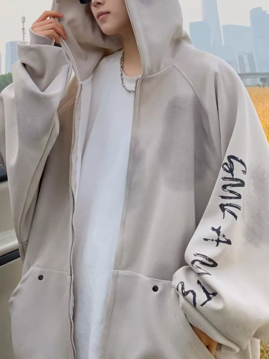 Oversized zip-up hoodie in apricot with graphic print on sleeve and front pockets.