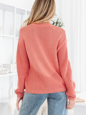 Burnt Coral knit sweater with crew neck and ribbed details.