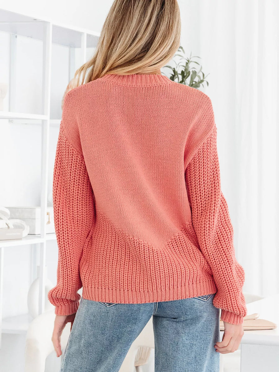 Burnt Coral knit sweater with crew neck and ribbed details.