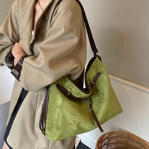 handbag in olive green featuring adjustable straps and relaxed fit