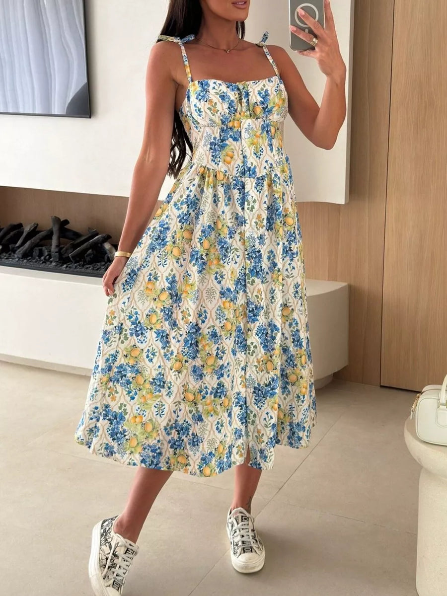 Floral tie-strap midi dress with a sweetheart neckline and A-line skirt in a blue and yellow fruit print.