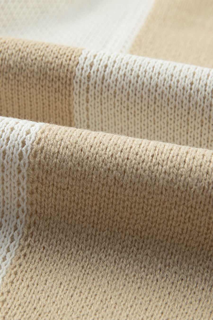 Colorblock checkerboard knit sweater in beige and cream acrylic fabric.