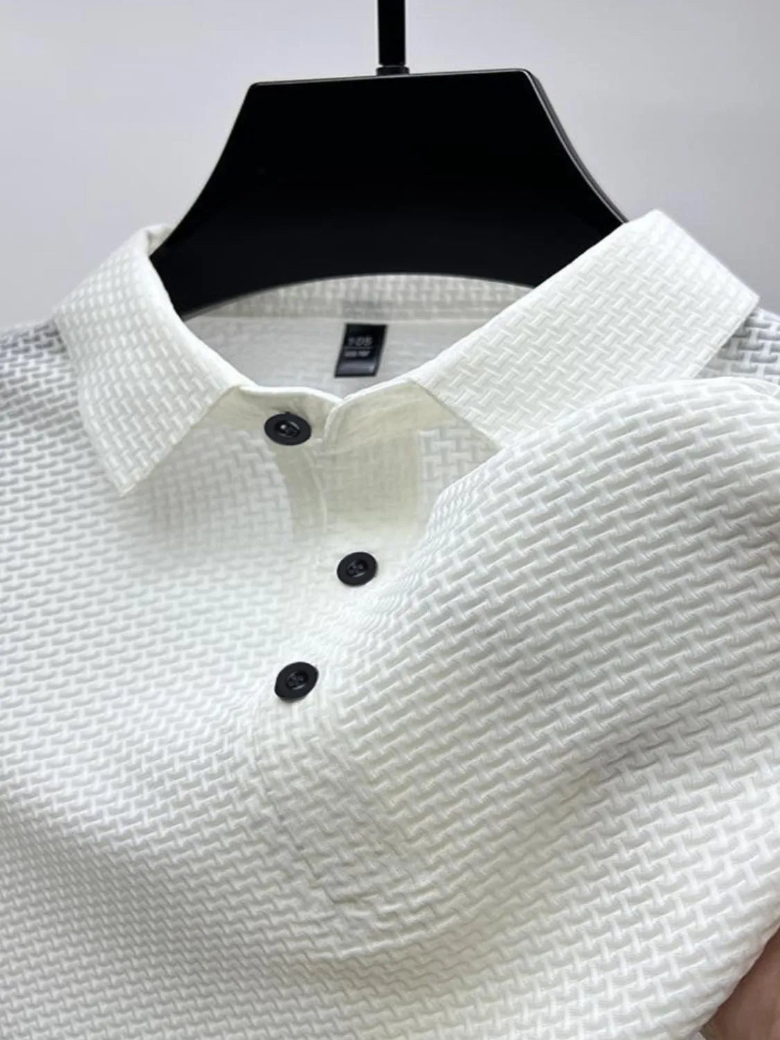 White textured weave polo shirt with maxi collar and black buttons