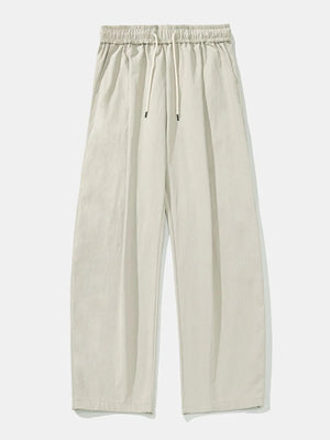 Balloon-fit drawstring trousers in light gray with a relaxed, casual style.