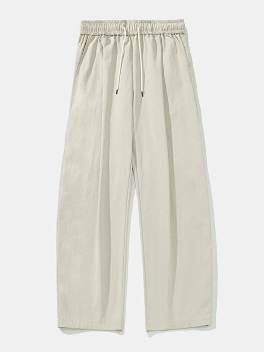 Balloon-fit drawstring trousers in light gray with a relaxed, casual style.