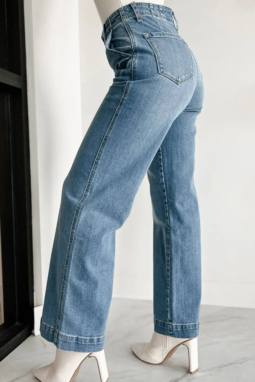 Button-fly wide-leg denim trousers in medium wash, featuring a high waist and flared leg.