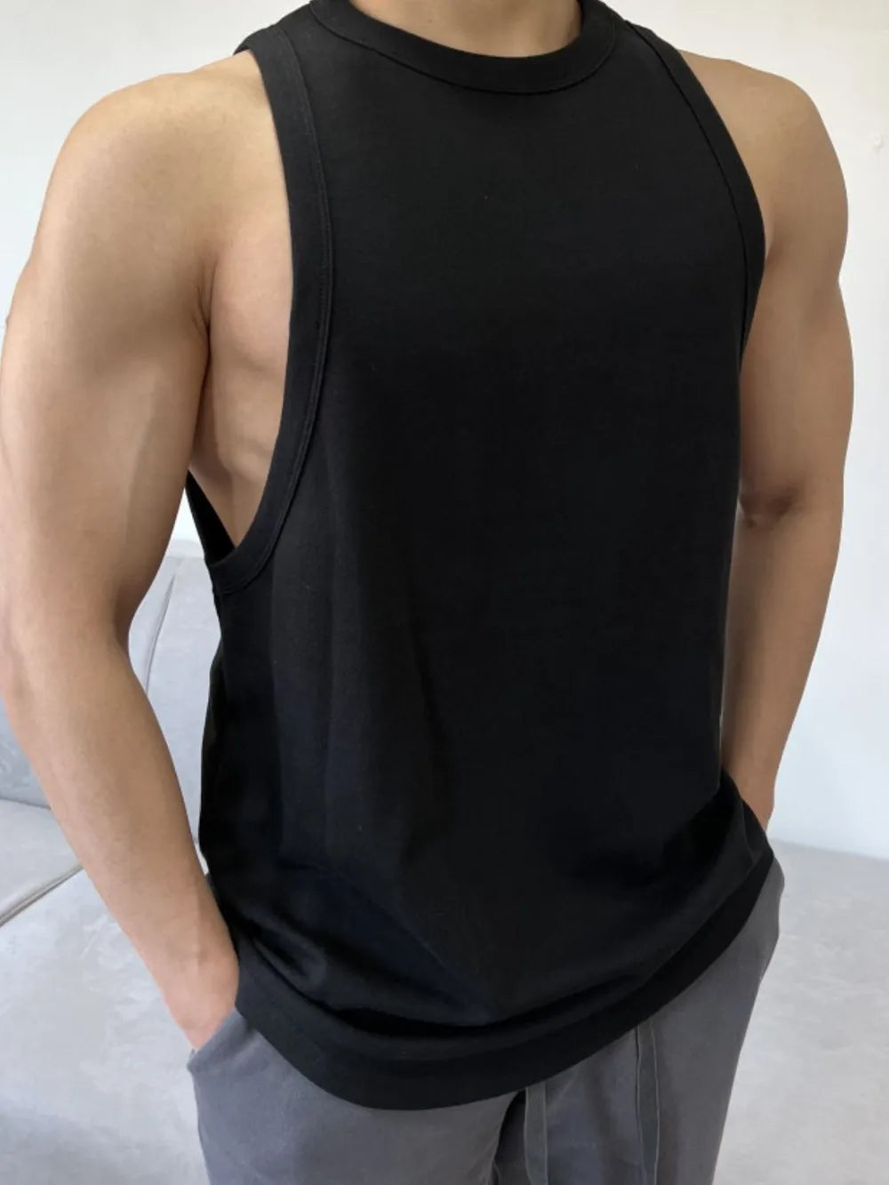 Black sculpted muscle tank with open sides and a crew neck.