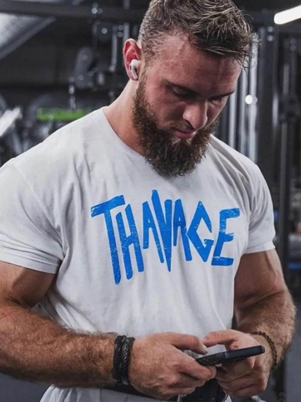 White oversized tee with blue Savage graphic print, crew neck, short sleeves.
