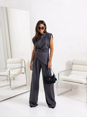 Gray satin cowl neck two-piece set with wide-leg pants and padded shoulders.