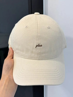 Cream white baseball cap with embroidered "plus" detail
