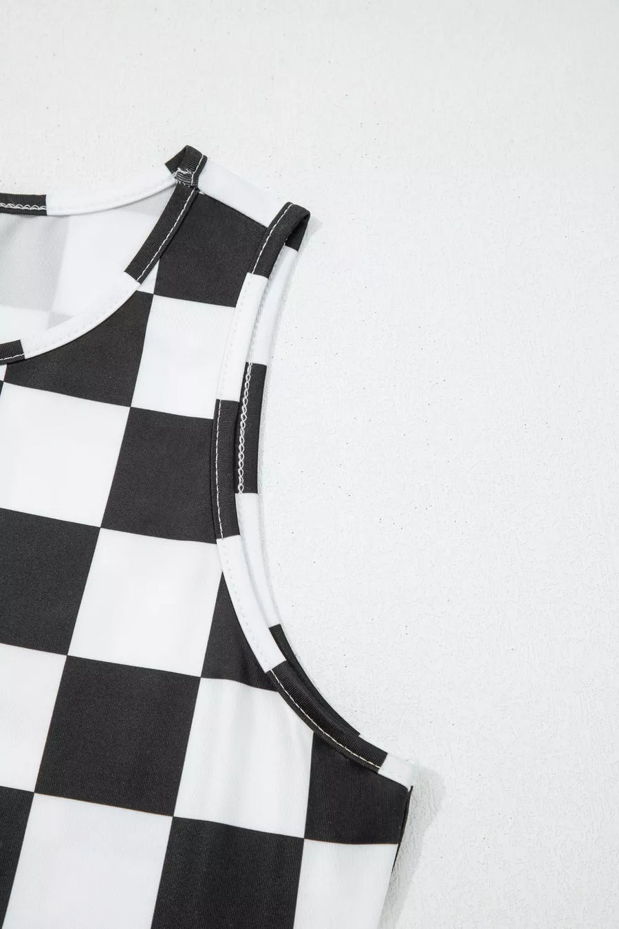 Graphic checkerboard seamless tank top with white trim and stitching.