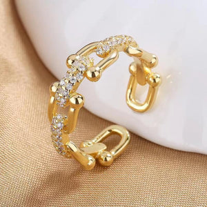 Gold color open chain-link ring with cubic zirconia accents and a U-shaped clasp.
