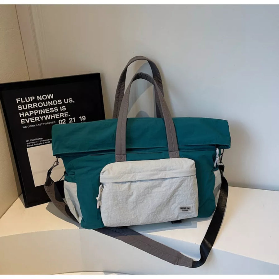 Tote bag in teal and white with grey straps and a front pocket