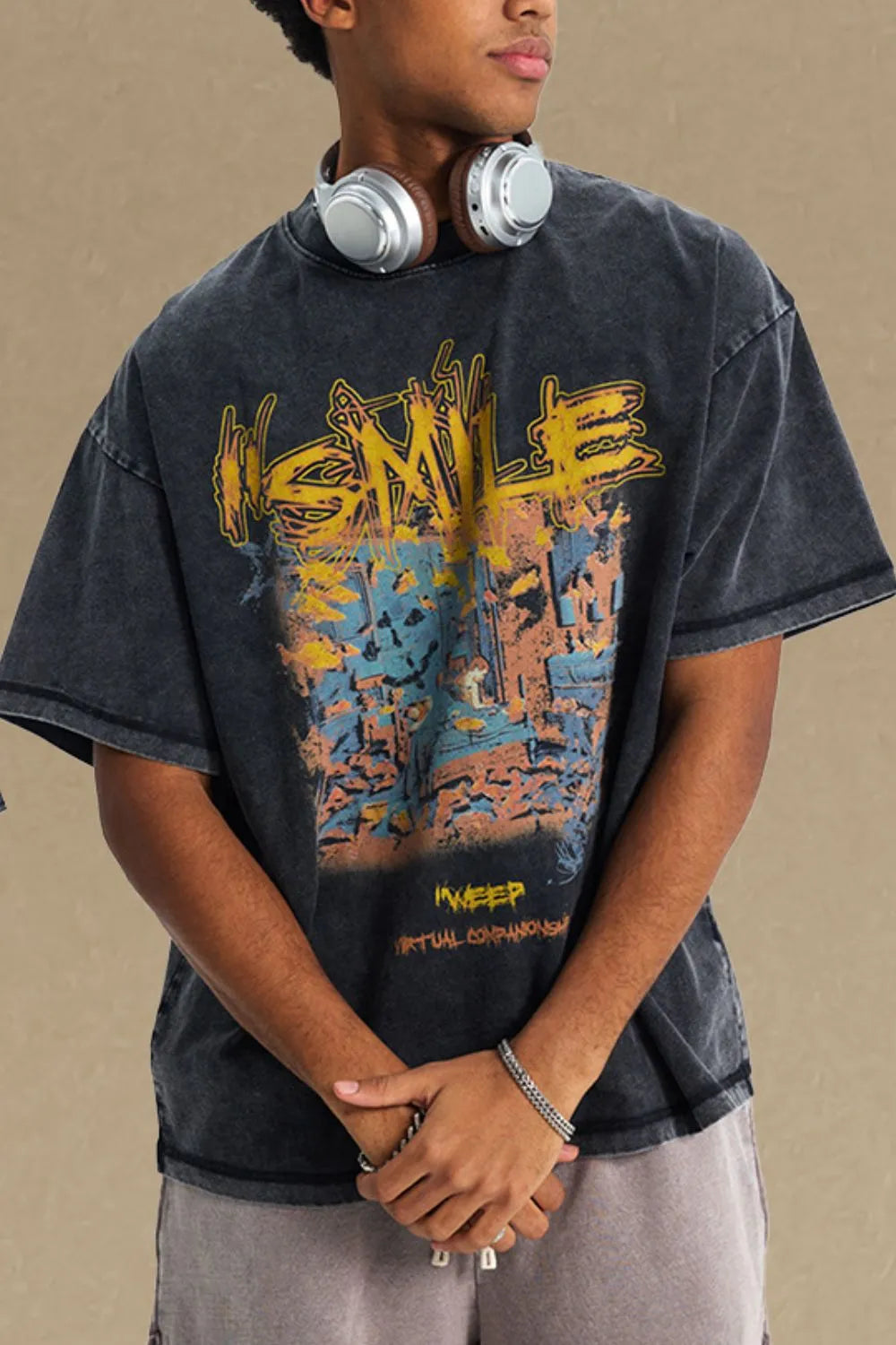 Washed black oversized graphic t-shirt with abstract art print and distressed details.
