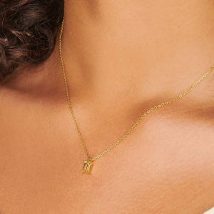 18K gold necklace with a single prism cut gemstone pendant.
