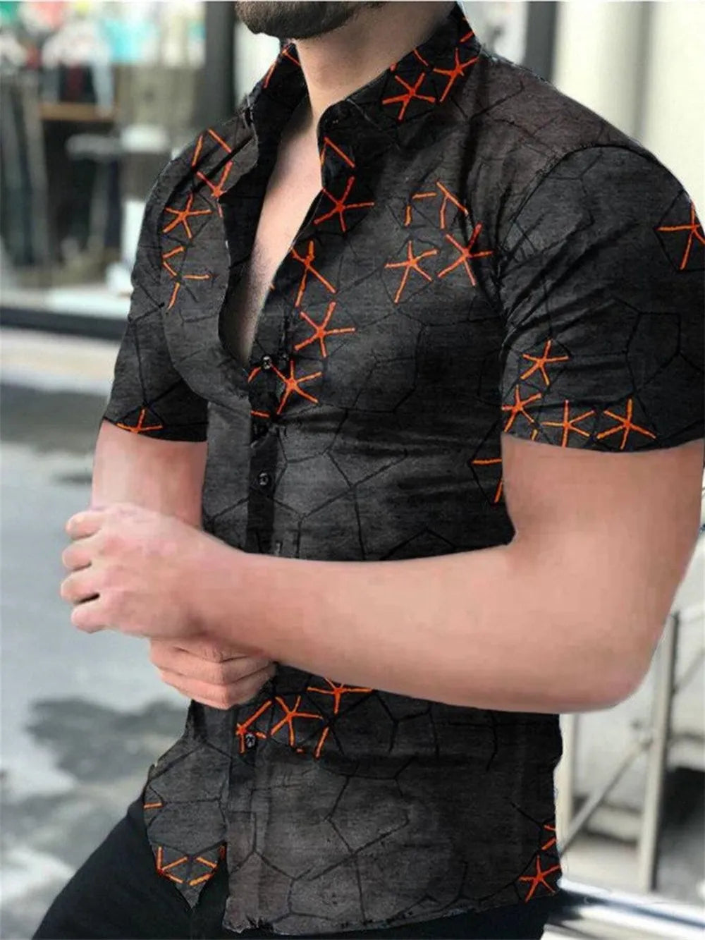 Short sleeve button-down shirt in black with abstract geometric and starburst print.