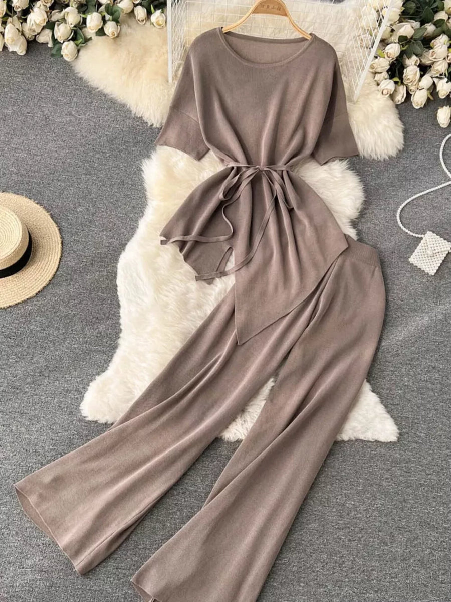 Tied waist knit two-piece set in apricot with short sleeves and wide leg pants.