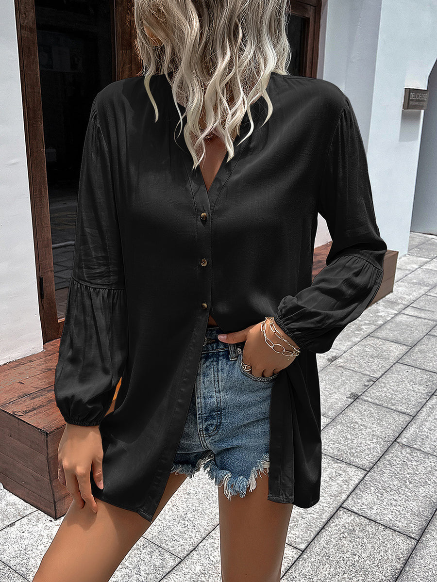Black oversized blouse with mandarin collar, button front, and balloon sleeves.