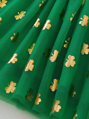 Green tulle dress with gold shamrock print and smocked detail.