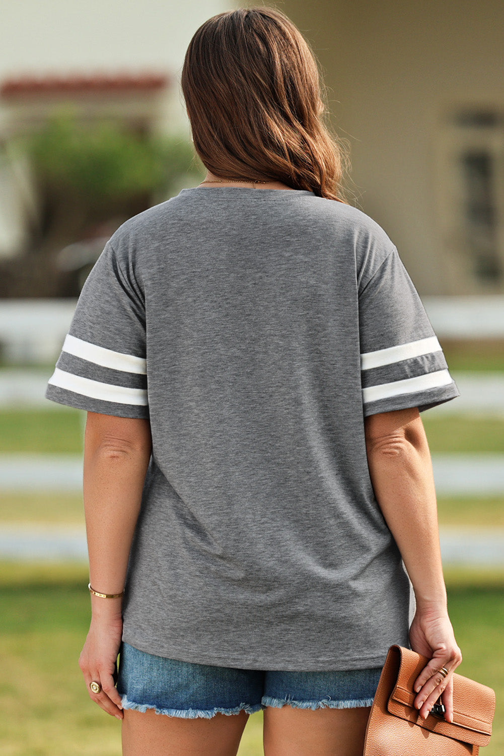 Dark gray t-shirt with white varsity stripes on the sleeves.