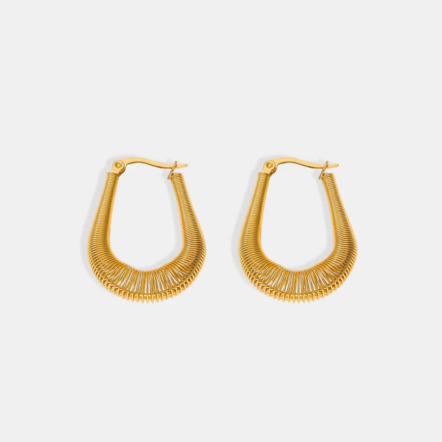 Gold coiled oval hoop earrings with a textured wire design.