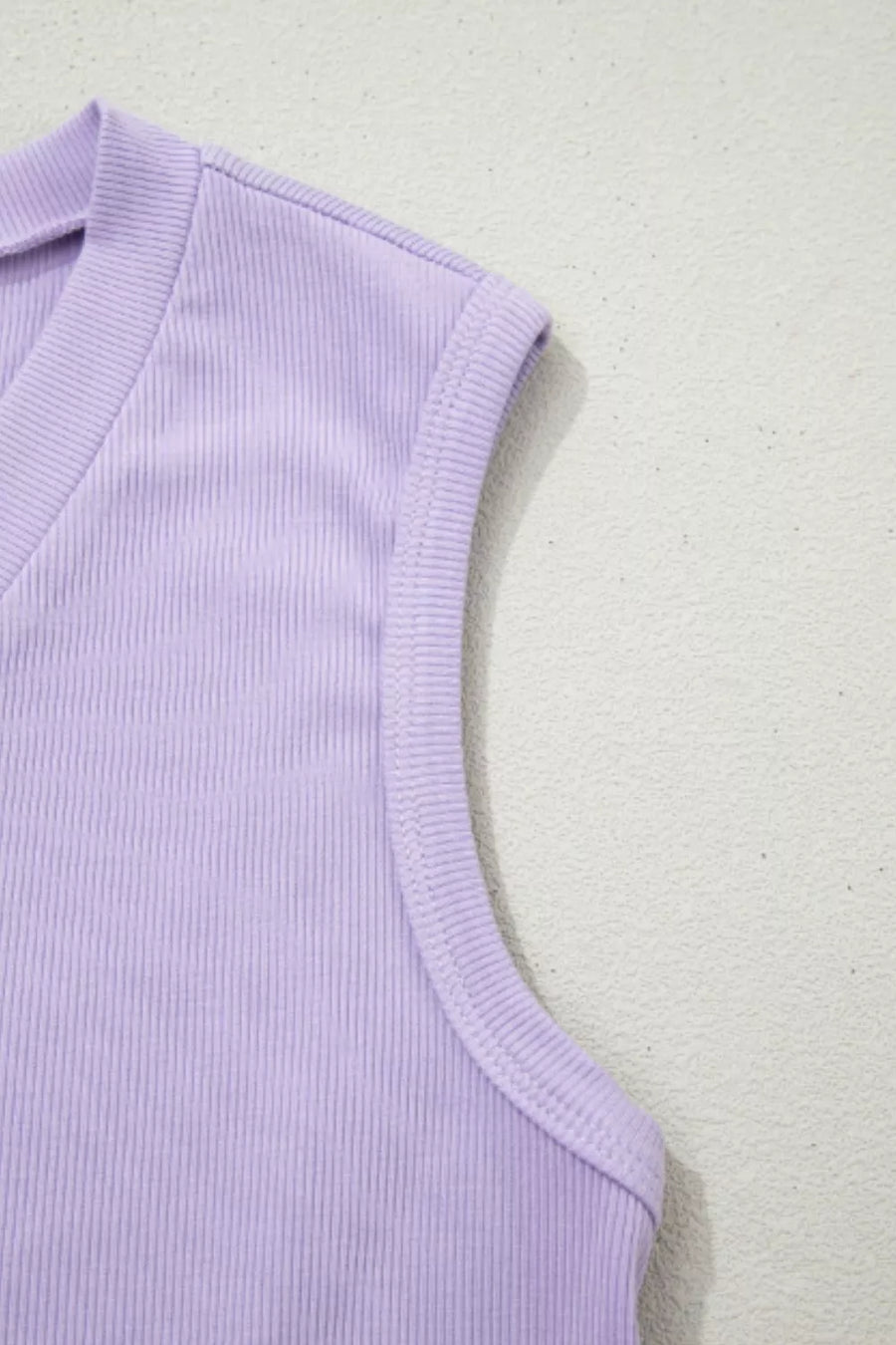 Lavender ribbed knit tank top with V-neck and sleeveless design.