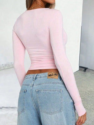 Blush pink long sleeve ruched crop top with a crew neck.